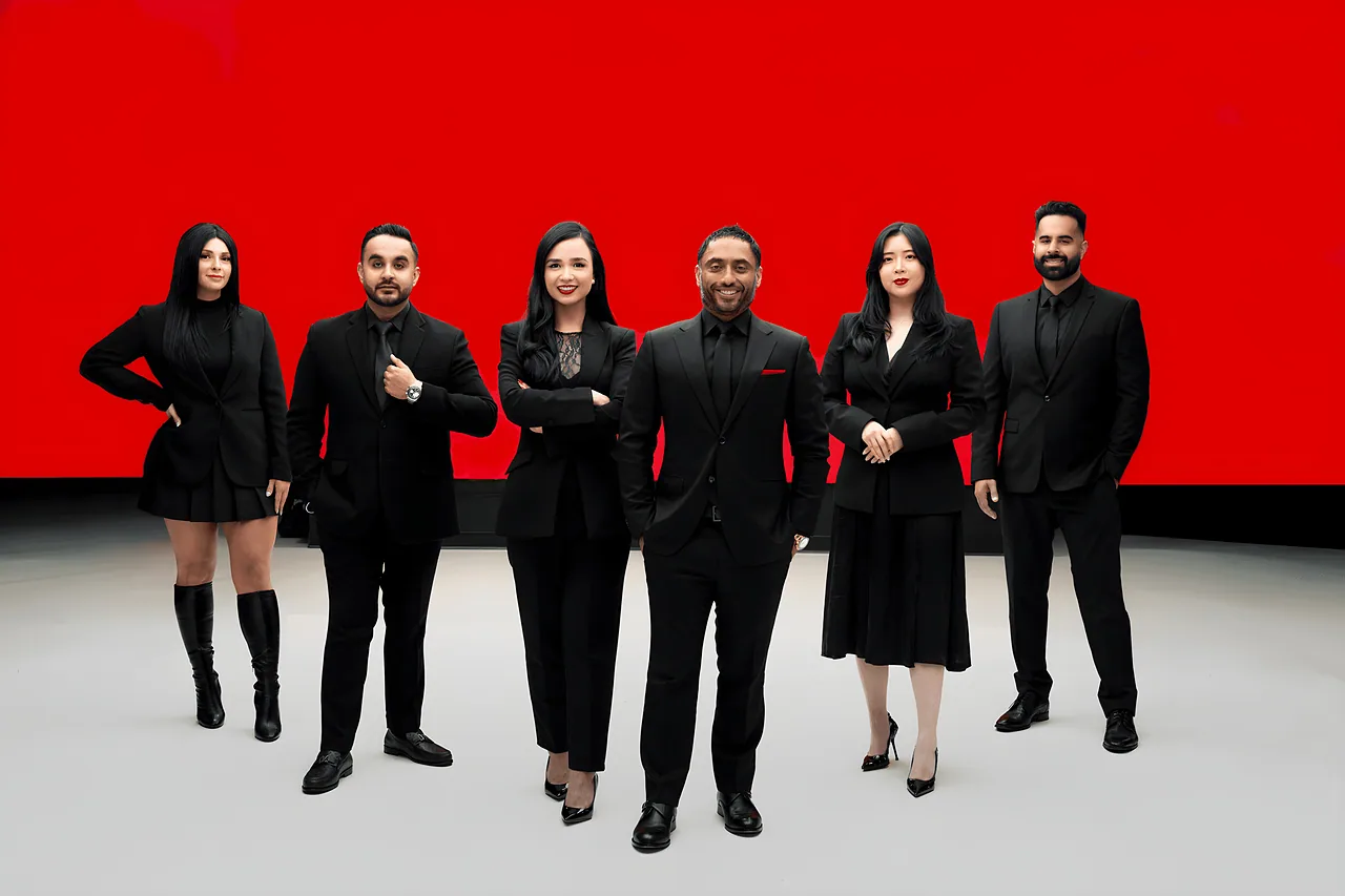 The Oberoi Group team in a red and white studio