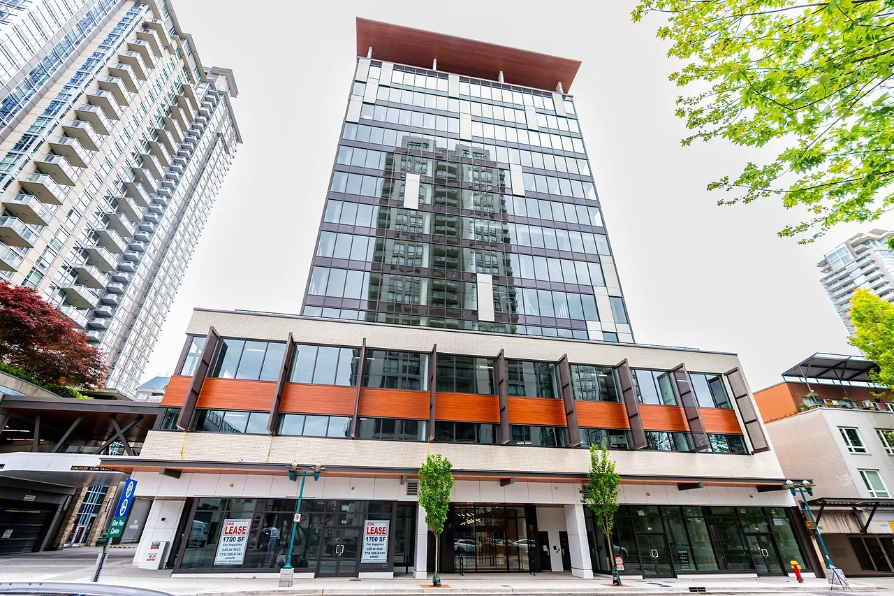 Mid-rise mixed-use building with shops at street level